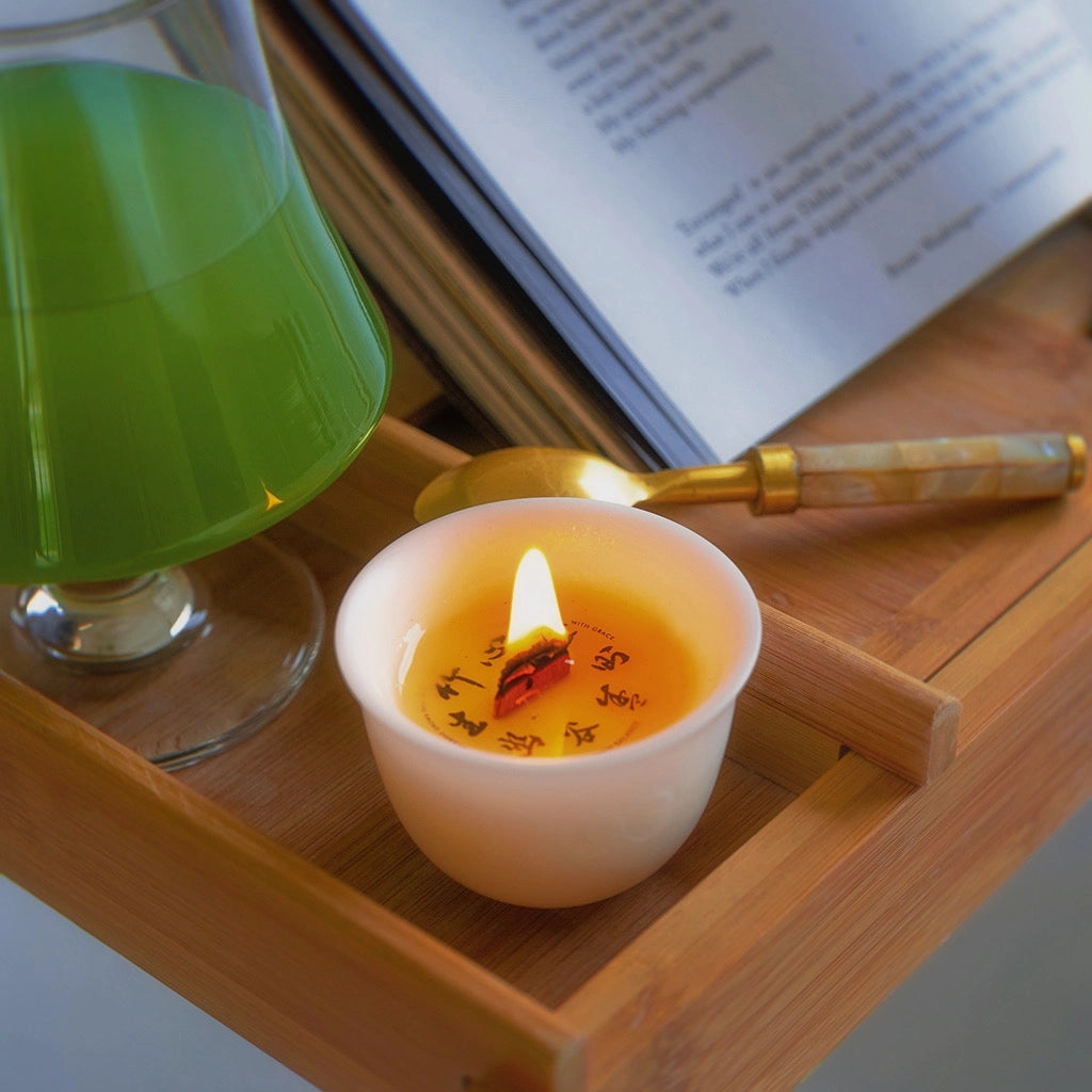 HerbloomZ Bamboo Zen Candle lit beside matcha and a book — calming soy candle for emotional balance and evening ritual