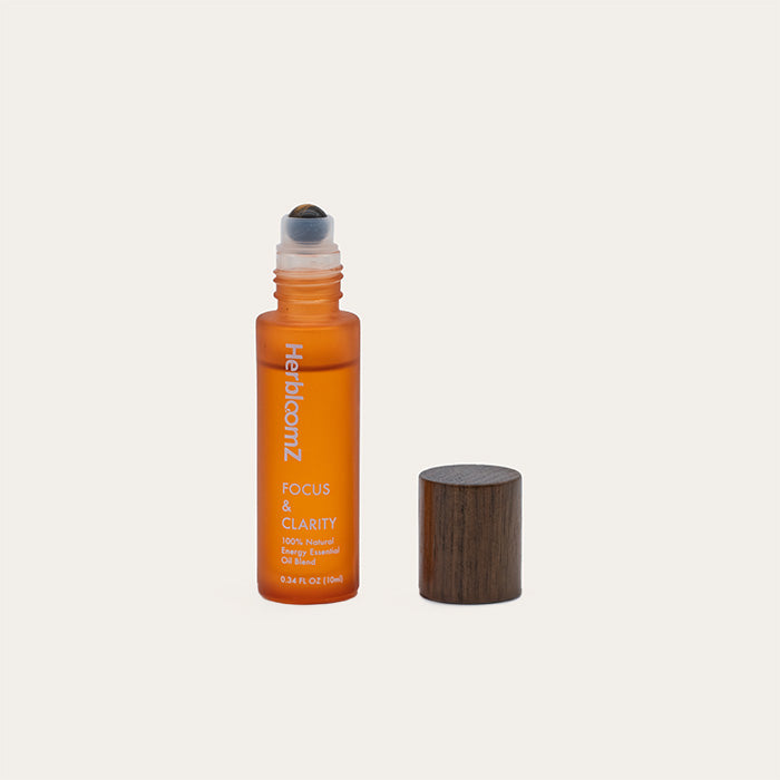 Open bottle of HerbloomZ Focus & Clarity essential oil with wooden cap — 100% natural roll-on for energy, focus, and stress relief. - HerbloomZ