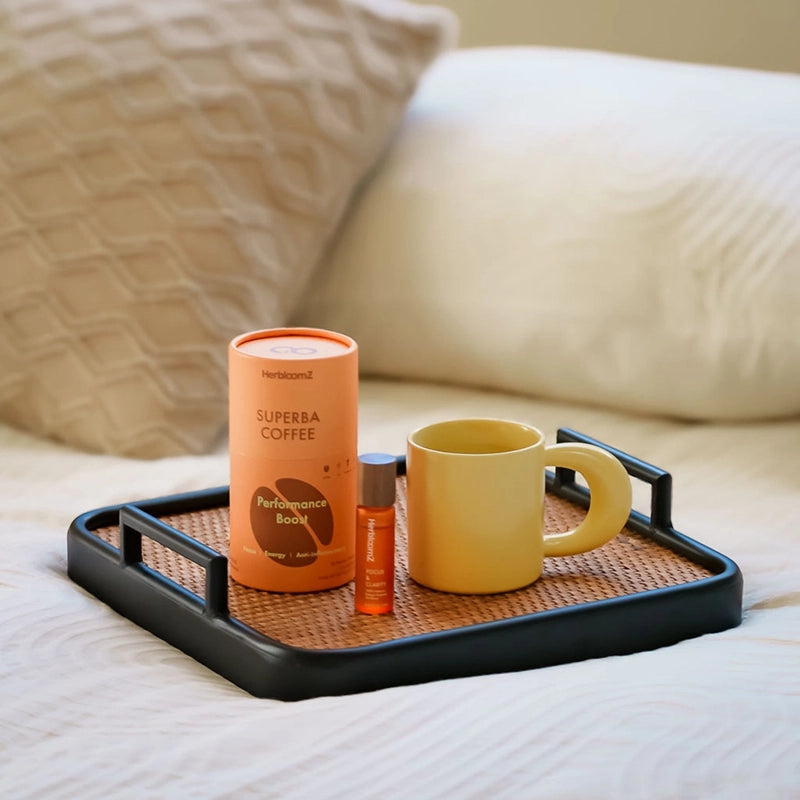 HerbloomZ SUPERBA mushroom coffee canister with Da Hong Pao oolong tea and yellow mug on bed tray, relaxing morning ritual without jitters