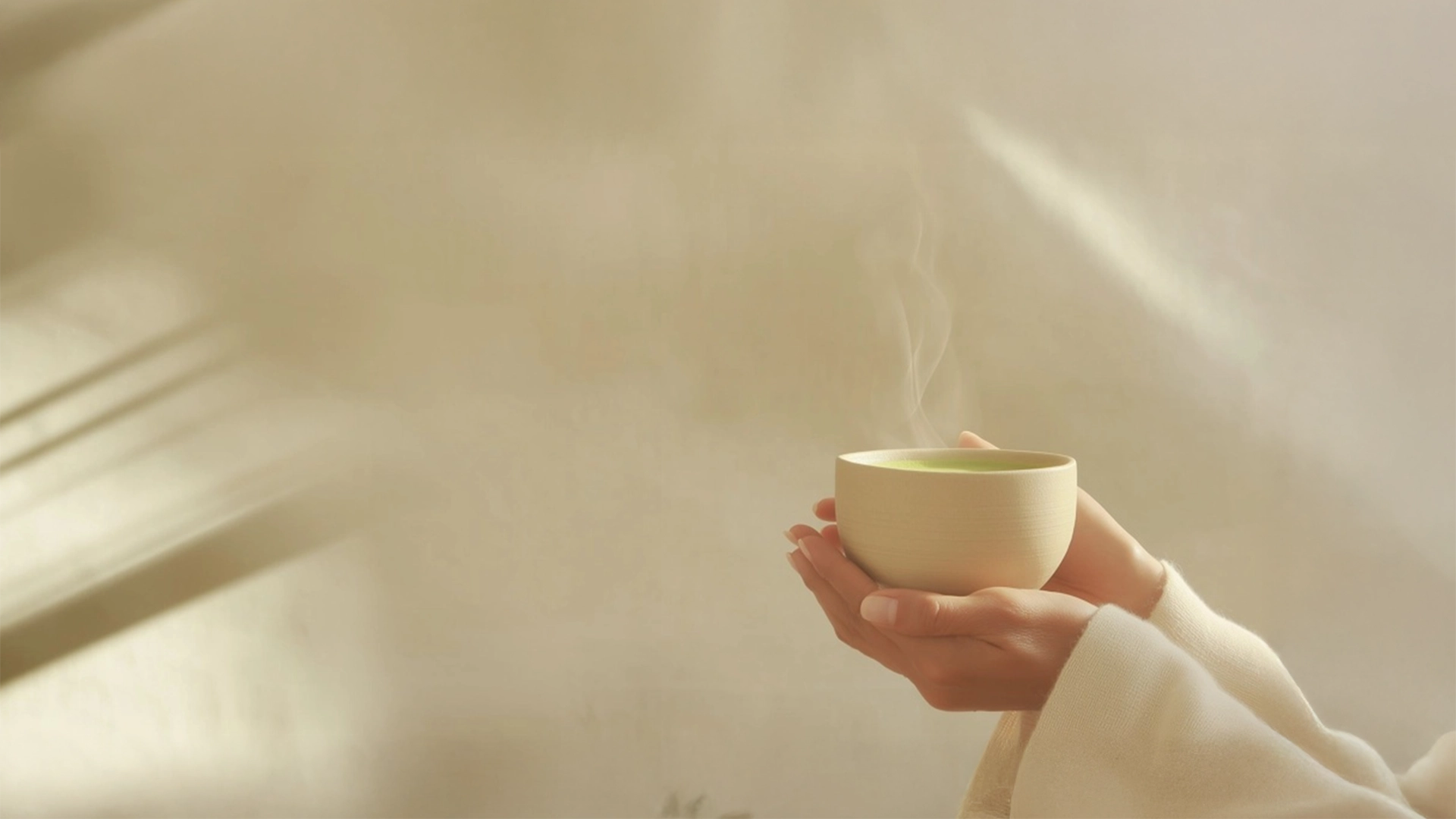 Hands holding a steaming cup of probiotic matcha — HerbloomZ wellness ritual for gut health, mood balance, and calm energy