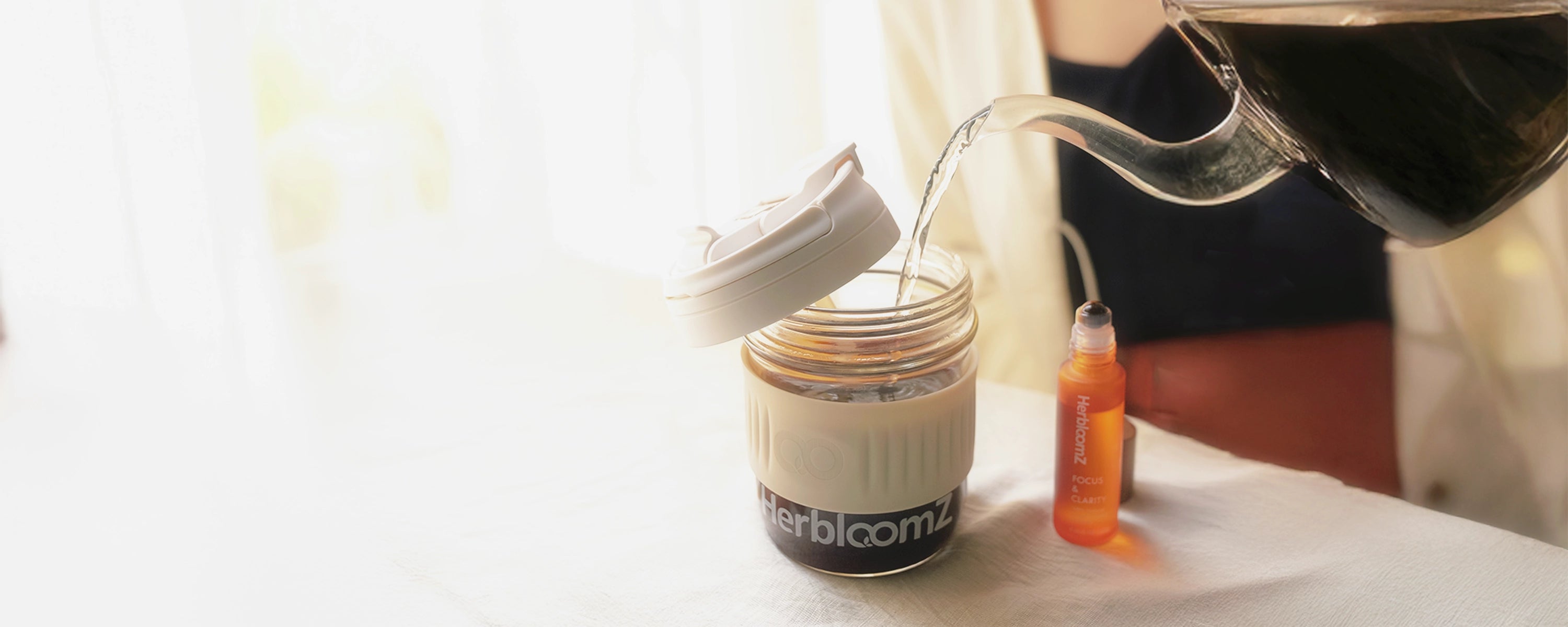 Hot water poured into HerbloomZ SUPERBA Coffee in reusable Wellness Cup with Focus Essential Oil nearby — ritual step 2 brew