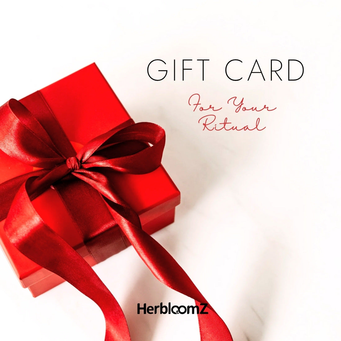 Red gift box with a bow on a white background, featuring 'HerbloomZ' brand.
