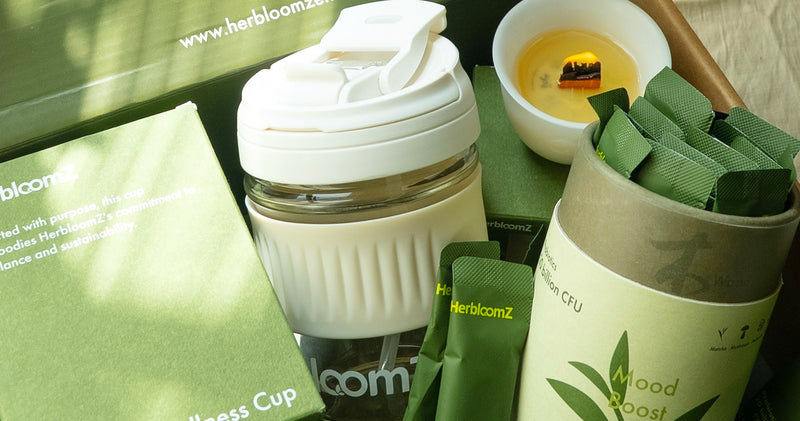 An open HerbloomZ gift box revealing the complete SUPERBA Matcha Set inside, with the probiotic matcha, wellness cup, and candle neatly arranged for a premium unboxing experience.