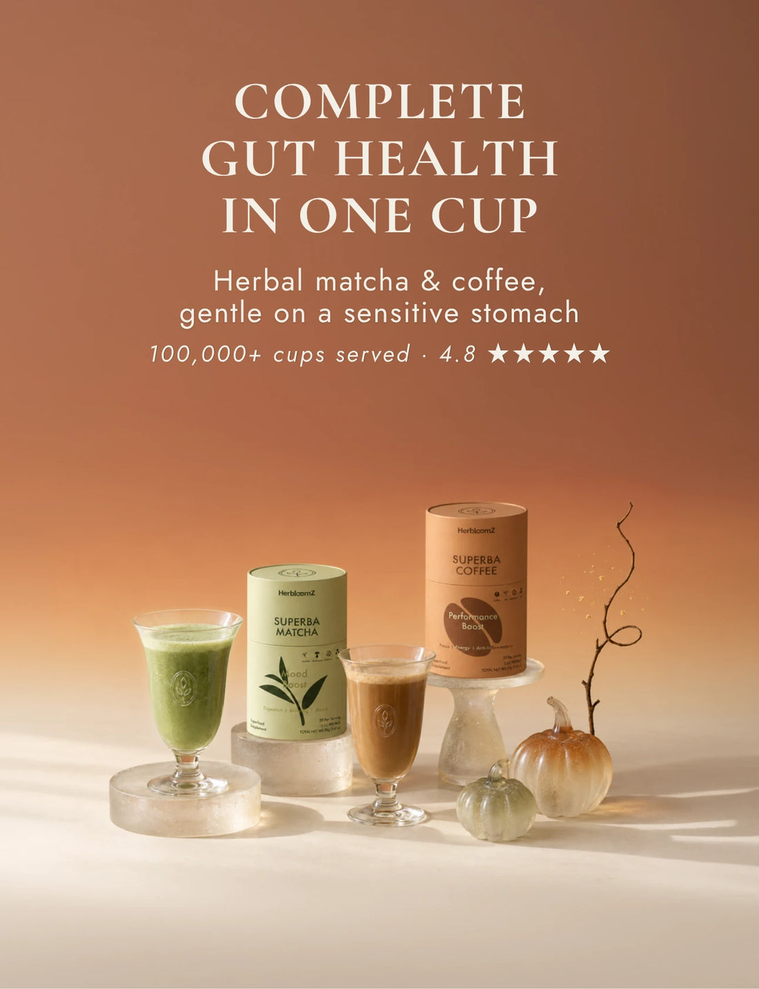 SUPERBA MATCHA and SUPERBA COFFEE tins with a matcha latte and a coffee in glass cups, next to two small glass pumpkins
