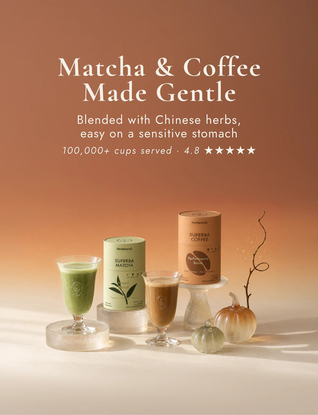 SUPERBA MATCHA and SUPERBA COFFEE tins with a matcha latte and a coffee in glass cups, next to two small glass pumpkins