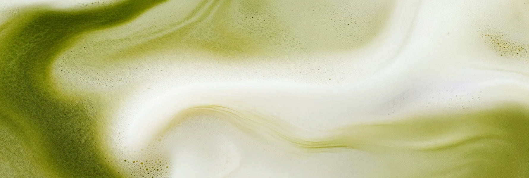 Close-up of SUPERBA probiotic matcha latte swirl, showing vibrant green tea and smooth milk foam — a sensory ritual for gut and mood balance.