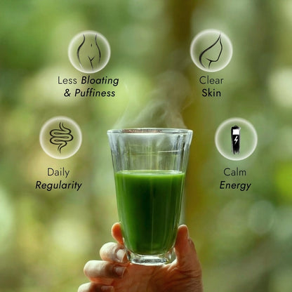 Hand holding a glass of superba matcha with health benefits listed on a blurred natural background