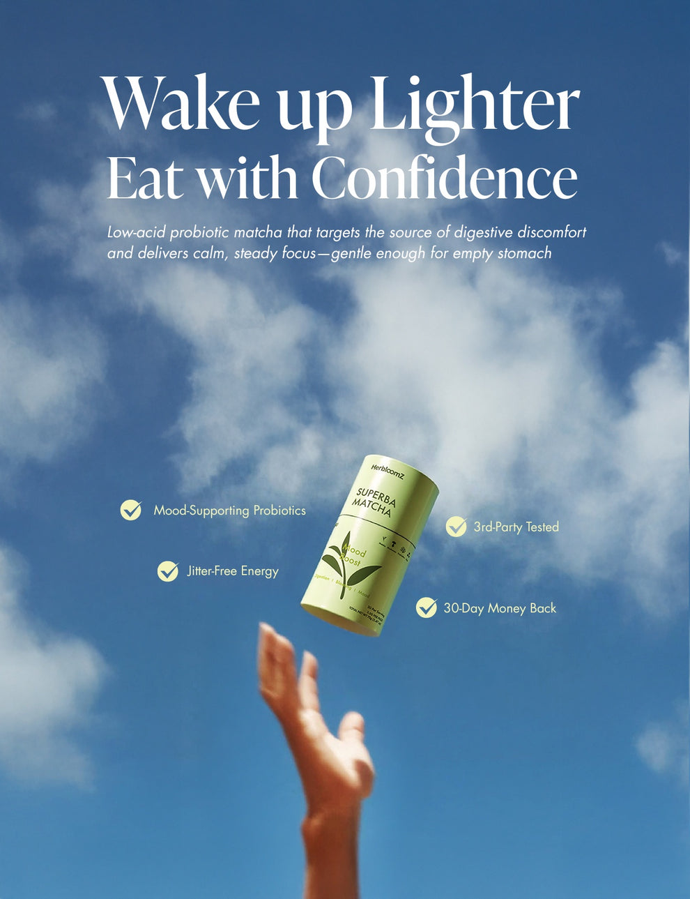 Hand reaching for a herbloomz probiotic matcha container against a blue sky with promotional text