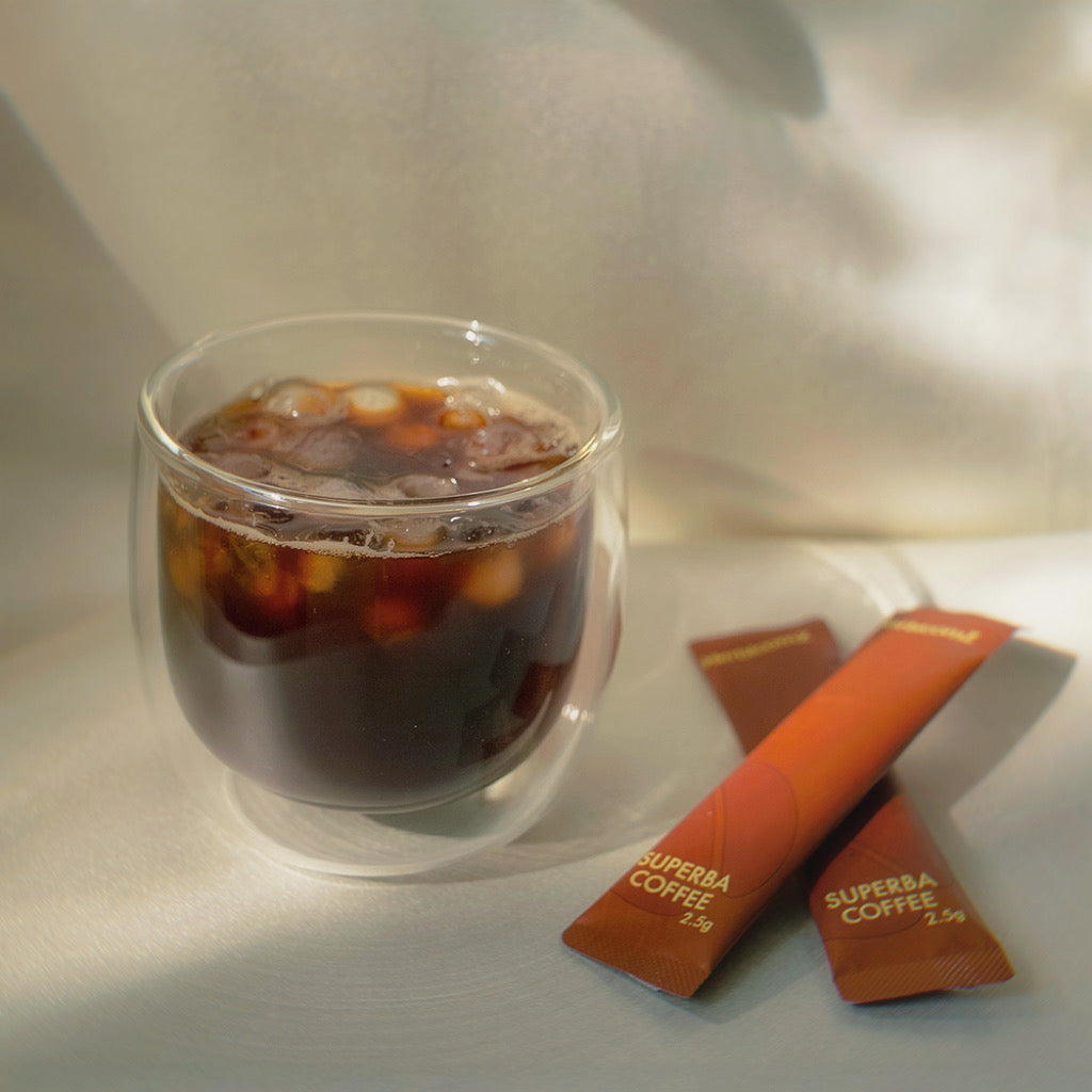 Iced HerbloomZ SUPERBA mushroom coffee with oolong tea sachets, refreshing adaptogenic drink for calm focus and gut-friendly energy